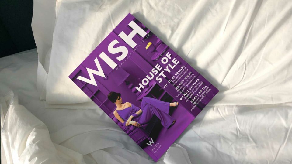 W Hotels WISH magazine cover on luxury bedding, showcasing the brand's upscale style
