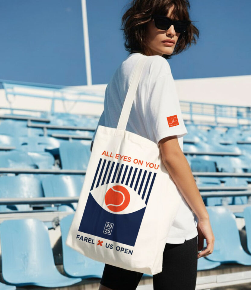 Model carrying PlanetFab Studio's Julien Farel US Open 2025 branding campaign 'All Eyes on You' tote bag