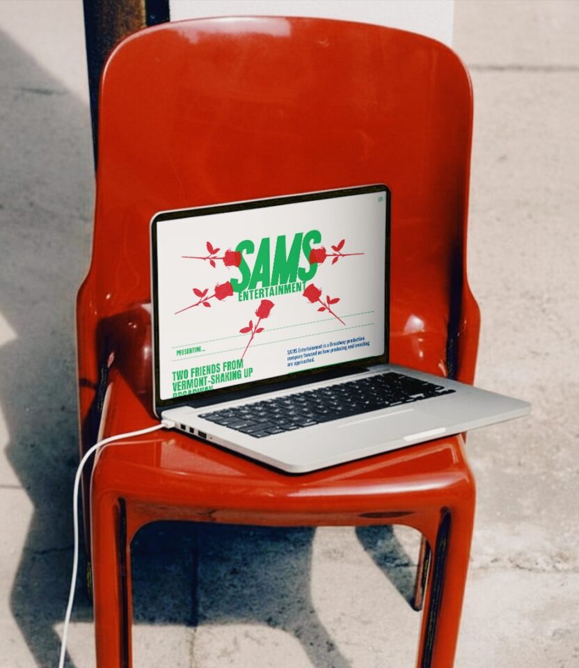 Laptop on red chair displaying SAMS Entertainment Broadway branding website designed by PlanetFab