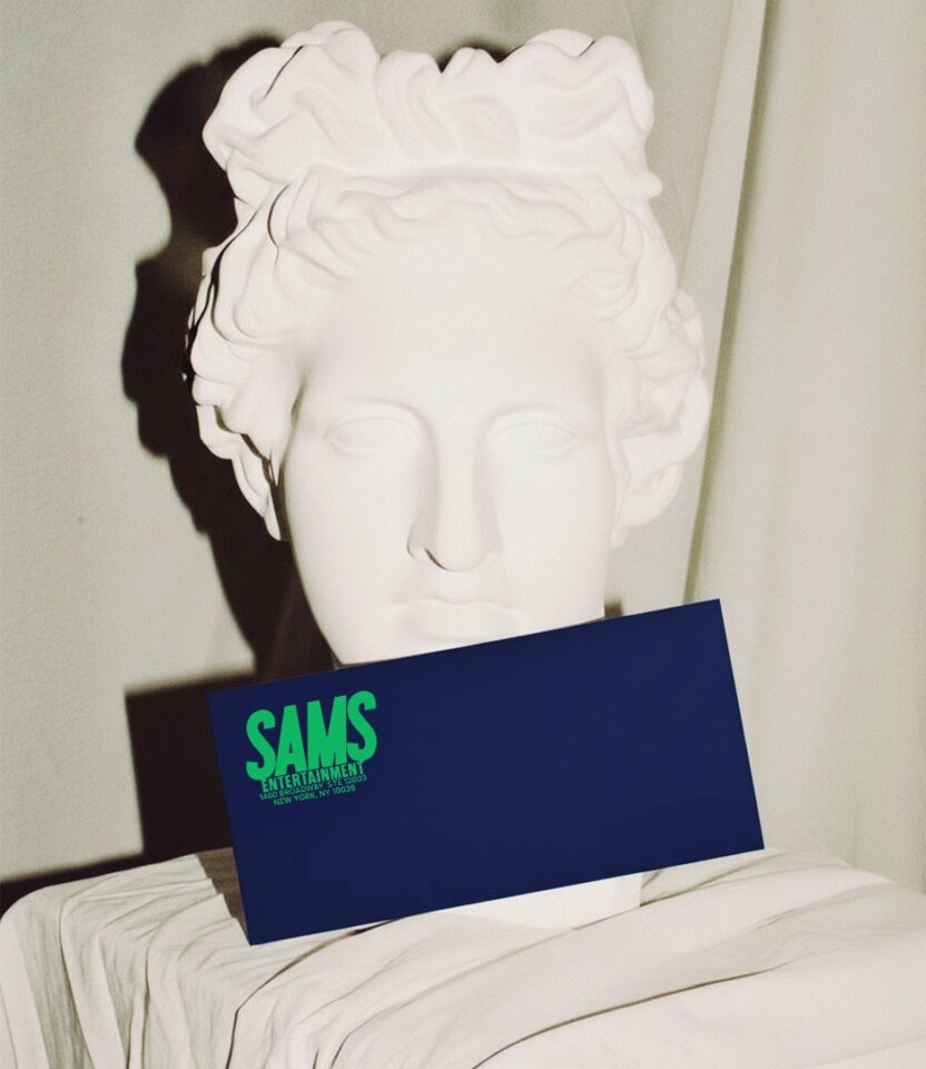 Navy envelope with SAMS Entertainment logo in green designed by PlanetFab