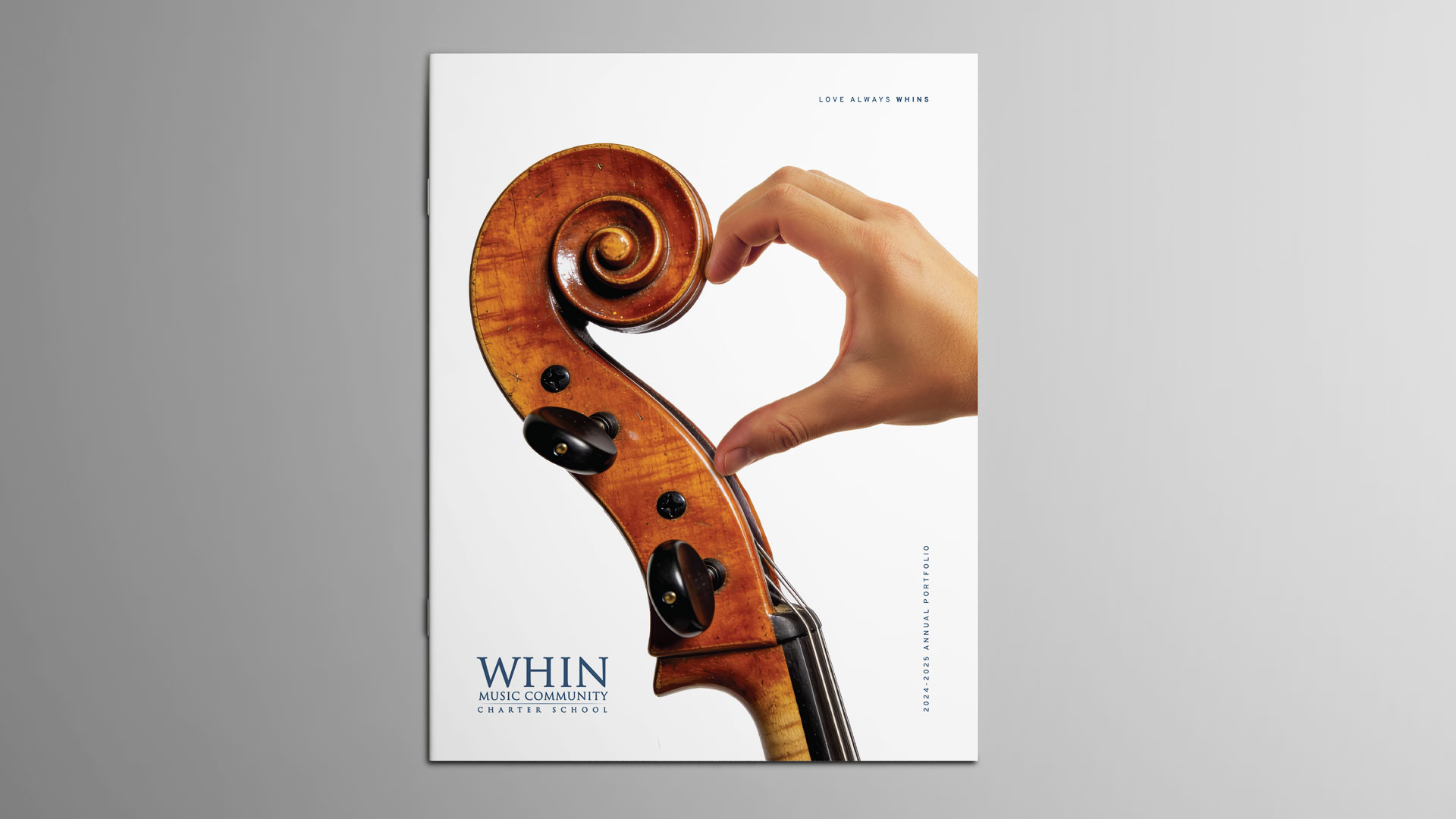 WHIN Music Community Charter School 2024-2025 Annual Portfolio cover, featuring a cello scroll and a hand together forming a heart shape, with the tagline "Love Always WHINS.